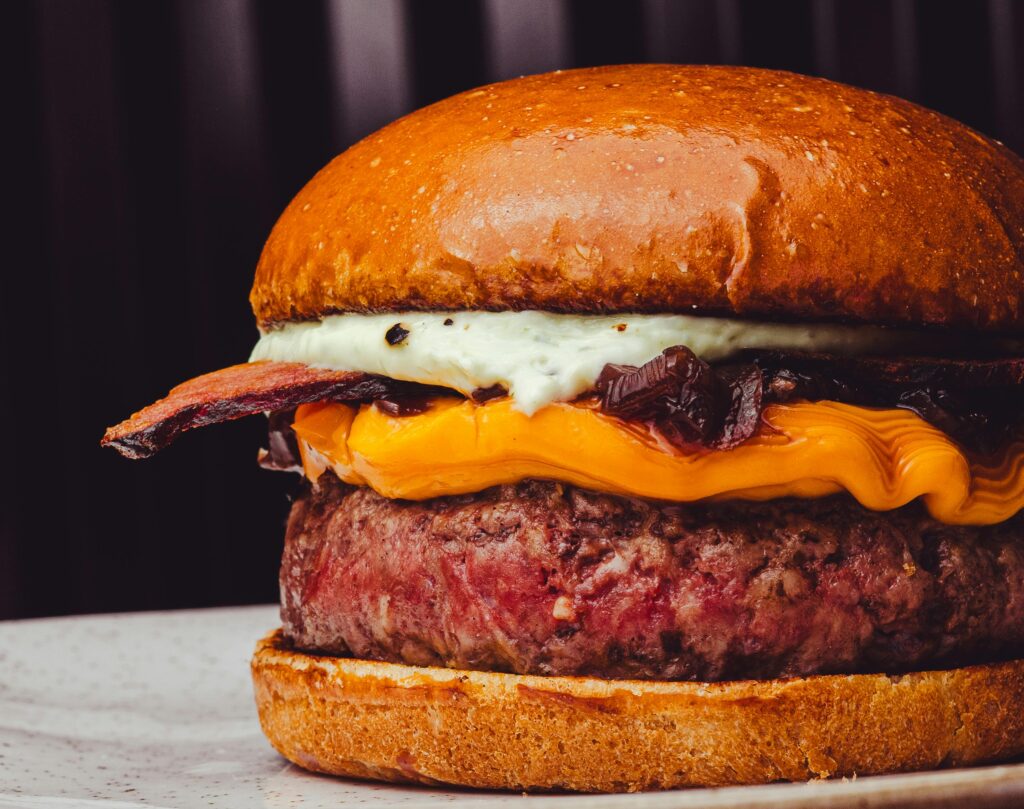 Delicious gourmet cheeseburger featuring juicy beef patty, cheddar cheese, and crispy bacon.